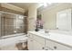 Bathroom features a white vanity with marble countertop and tiled shower with a glass door at 2916 Kings Walk Ave, Marietta, GA 30062