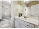 Bright bathroom with a white vanity, white countertops, modern fixtures and a shower and tub at 2916 Kings Walk Ave, Marietta, GA 30062