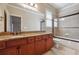 Bathroom with granite countertops and a glass-enclosed bathtub with shower at 2916 Kings Walk Ave, Marietta, GA 30062