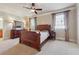 Spacious bedroom with carpeted floor, tray ceiling, and a large window with light-filtering curtains at 2916 Kings Walk Ave, Marietta, GA 30062