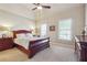 Bedroom with a dark wood bed frame, carpet, and natural light from the window at 2916 Kings Walk Ave, Marietta, GA 30062