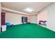 Carpeted bonus room features a treadmill, storage, and access to a storage area with colorful floor mats at 2916 Kings Walk Ave, Marietta, GA 30062