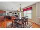 Elegant dining room features a chandelier, hardwood floors, and is open to the kitchen at 2916 Kings Walk Ave, Marietta, GA 30062