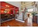 Elegant foyer showcasing hardwood floors, a staircase with iron railings, and a view into the dining room at 2916 Kings Walk Ave, Marietta, GA 30062