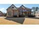 Charming two-story home with a brick and stone facade, complemented by a well-manicured front yard at 2916 Kings Walk Ave, Marietta, GA 30062