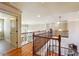 Elegant hallway featuring hardwood floors, wrought iron railing, and a view to the front entrance and chandelier at 2916 Kings Walk Ave, Marietta, GA 30062