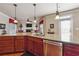 Open-concept kitchen with granite countertops, a stainless steel dishwasher, and rich wood cabinetry at 2916 Kings Walk Ave, Marietta, GA 30062