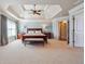Spacious main bedroom with tray ceiling, large windows, and a king-size bed with bench at 2916 Kings Walk Ave, Marietta, GA 30062