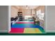 Storage area with colorful floor mats, shelves, work table, and ample space for organizing items at 2916 Kings Walk Ave, Marietta, GA 30062