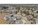 Aerial shot of a neighborhood with large homes nestled among trees and a serene lake nearby at 4235 Iron Duke Ct, Peachtree Corners, GA 30097