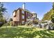 Two story brick home featuring a backyard pool and deck at 4235 Iron Duke Ct, Peachtree Corners, GA 30097