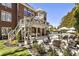 Outdoor living space featuring a firepit, pool, landscaped yard, and a multi-level deck for entertaining at 4235 Iron Duke Ct, Peachtree Corners, GA 30097
