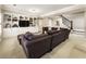 Finished basement with a large sectional, built-in shelving, and access to the stairs at 4235 Iron Duke Ct, Peachtree Corners, GA 30097