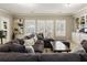 Spacious basement with a large sectional, built-in shelving, and french doors at 4235 Iron Duke Ct, Peachtree Corners, GA 30097