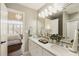 Bright bathroom with double sinks, granite countertops, and a view to the main bedroom at 4235 Iron Duke Ct, Peachtree Corners, GA 30097