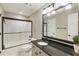 Bathroom featuring granite vanity with black hardware, framed mirror, and shower-tub combo with black hardware at 4235 Iron Duke Ct, Peachtree Corners, GA 30097