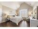 Elegant bedroom with vaulted ceilings, a chandelier, and a large window with plantation shutters at 4235 Iron Duke Ct, Peachtree Corners, GA 30097