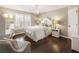Cozy bedroom features plantation shutters, a chandelier, and hardwood floors at 4235 Iron Duke Ct, Peachtree Corners, GA 30097
