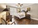 Comfortable bedroom with hardwood floors, a ceiling fan, and neutral decor for a cozy retreat at 4235 Iron Duke Ct, Peachtree Corners, GA 30097