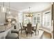 Bright dining room features a round table, antler chandelier, and a large window providing natural light at 4235 Iron Duke Ct, Peachtree Corners, GA 30097