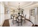 Elegant dining room featuring wainscoting, chandelier, and hardwood floors at 4235 Iron Duke Ct, Peachtree Corners, GA 30097