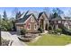 Beautiful brick home featuring a manicured front yard, attached garage, and classic architectural details at 4235 Iron Duke Ct, Peachtree Corners, GA 30097