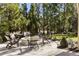 Cozy backyard firepit area with Adirondack chairs, surrounded by lush greenery, perfect for relaxation and entertainment at 4235 Iron Duke Ct, Peachtree Corners, GA 30097