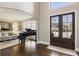 Grand foyer featuring a piano and a view into the formal living room, complemented by rich hardwood floors at 4235 Iron Duke Ct, Peachtree Corners, GA 30097