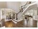 Grand staircase and foyer with hardwood floors, open dining room and living space at 4235 Iron Duke Ct, Peachtree Corners, GA 30097