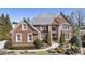 Beautiful two-story brick home with manicured landscaping and symmetrical design at 4235 Iron Duke Ct, Peachtree Corners, GA 30097