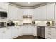 Well-appointed kitchen showcasing white cabinets, stainless steel appliances, granite countertops, and modern fixtures at 4235 Iron Duke Ct, Peachtree Corners, GA 30097