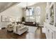 Open-concept living area features vaulted ceilings, a large sectional, a fireplace, and an abundance of natural light at 4235 Iron Duke Ct, Peachtree Corners, GA 30097