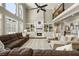 Great room with a fireplace and custom built-ins, complemented by tall windows and a comfortable seating arrangement at 4235 Iron Duke Ct, Peachtree Corners, GA 30097