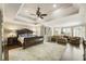 Large main bedroom featuring tray ceiling, sitting area and shuttered windows at 4235 Iron Duke Ct, Peachtree Corners, GA 30097