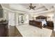 Spacious main bedroom with a tray ceiling, dark wood furniture, and walk-in closet access at 4235 Iron Duke Ct, Peachtree Corners, GA 30097