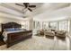 Spacious main bedroom featuring tray ceilings, sitting area, and hardwood floors at 4235 Iron Duke Ct, Peachtree Corners, GA 30097