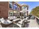 Spacious outdoor patio with comfortable seating, an umbrella, and a grill for outdoor entertaining at 4235 Iron Duke Ct, Peachtree Corners, GA 30097