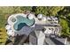 Aerial view of a private backyard oasis with a pool, spa, patio, fire pit, and lush landscaping at 4235 Iron Duke Ct, Peachtree Corners, GA 30097