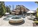 Expansive backyard pool and spa with ample seating and mature landscaping, ideal for outdoor entertaining at 4235 Iron Duke Ct, Peachtree Corners, GA 30097