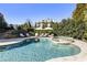 Backyard pool and spa surrounded by lush landscaping and a stone patio creates a serene and luxurious outdoor space at 4235 Iron Duke Ct, Peachtree Corners, GA 30097