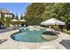 Stunning pool area with a spa, lounge chairs, umbrellas, and lush landscaping for a luxurious outdoor retreat at 4235 Iron Duke Ct, Peachtree Corners, GA 30097