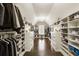 Large walk-in closet featuring custom shelves and a center island at 4235 Iron Duke Ct, Peachtree Corners, GA 30097