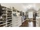 Bright walk-in closet featuring custom shelves and hardwood floors at 4235 Iron Duke Ct, Peachtree Corners, GA 30097
