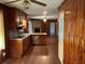 Cozy kitchen with wood cabinets, laminate countertops, stainless steel appliances, and wood-paneled walls at 2374 Woodcastle Se Ln, Atlanta, GA 30316