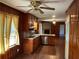 Cozy kitchen with wood cabinets, laminate countertops, stainless steel appliances, and wood-paneled walls at 2374 Woodcastle Se Ln, Atlanta, GA 30316