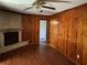 Living room with brick fireplace and wood-paneled walls at 2374 Woodcastle Se Ln, Atlanta, GA 30316