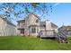 Exterior of a home with a large, green backyard and a wooden deck at 3649 Salem Glen Rd, Lithonia, GA 30038