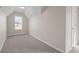 Cozy bedroom featuring carpet, window, and neutral paint at 3649 Salem Glen Rd, Lithonia, GA 30038