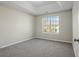 Bedroom with neutral paint, new carpet flooring and a window providing natural light at 3649 Salem Glen Rd, Lithonia, GA 30038