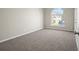 Bedroom with new carpeting, neutral paint and ample natural light from a large, arched window at 3649 Salem Glen Rd, Lithonia, GA 30038